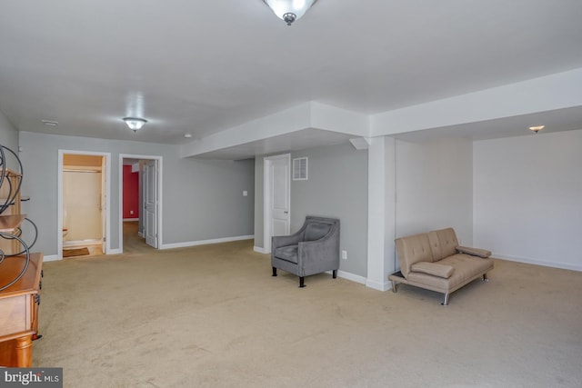 sitting room with carpet floors, visible vents, and baseboards