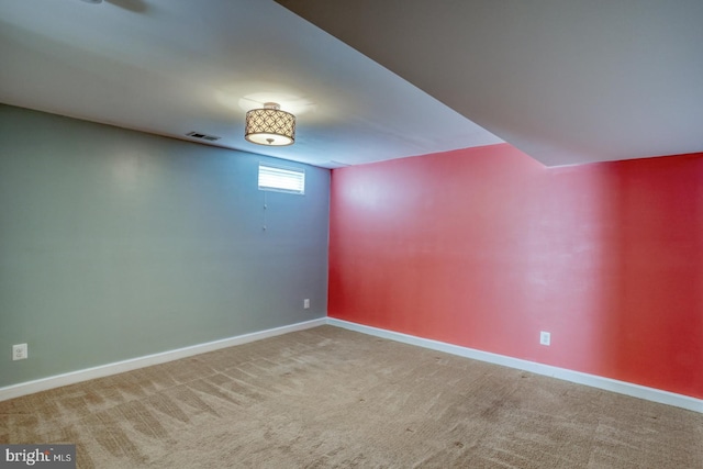 unfurnished room featuring carpet floors and baseboards