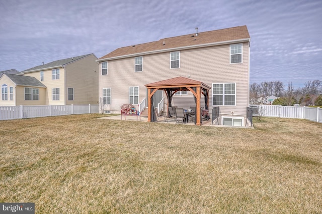 rear view of property featuring a patio area, a fenced backyard, a yard, and a gazebo