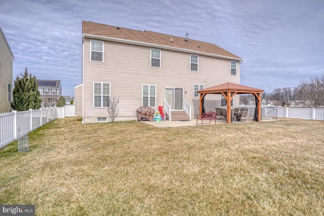 rear view of house featuring entry steps, a gazebo, a yard, and a patio area