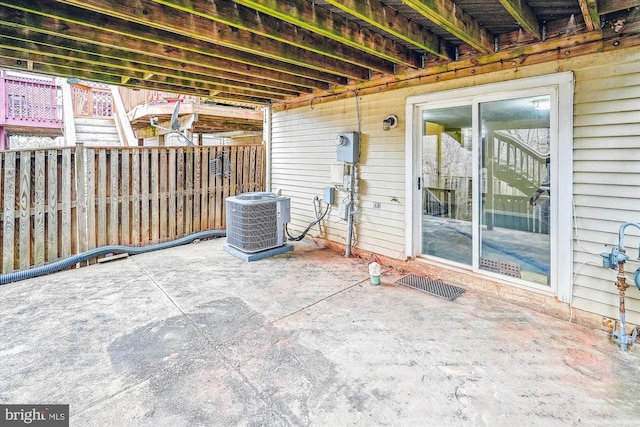 view of patio featuring fence and cooling unit