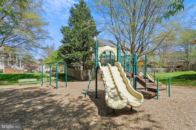 communal playground with a lawn and fence