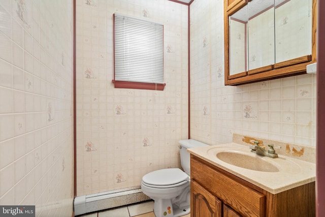 bathroom featuring baseboard heating, tile patterned flooring, tile walls, vanity, and toilet