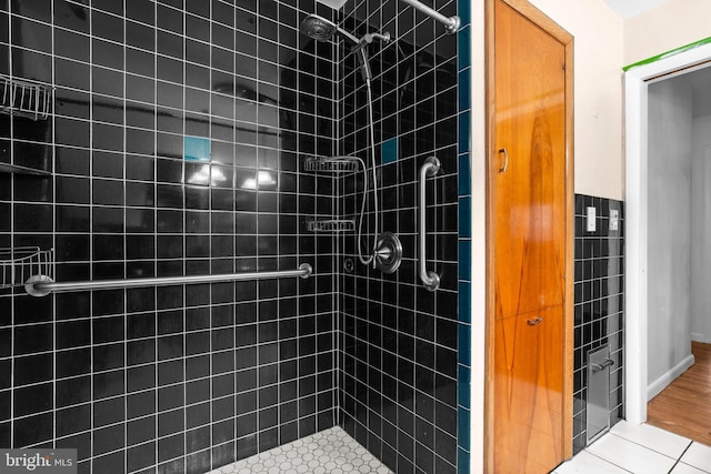 bathroom featuring a tile shower and tile patterned floors