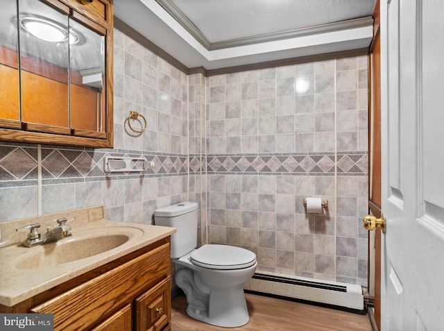 bathroom with ornamental molding, hardwood / wood-style floors, tile walls, and a baseboard heating unit