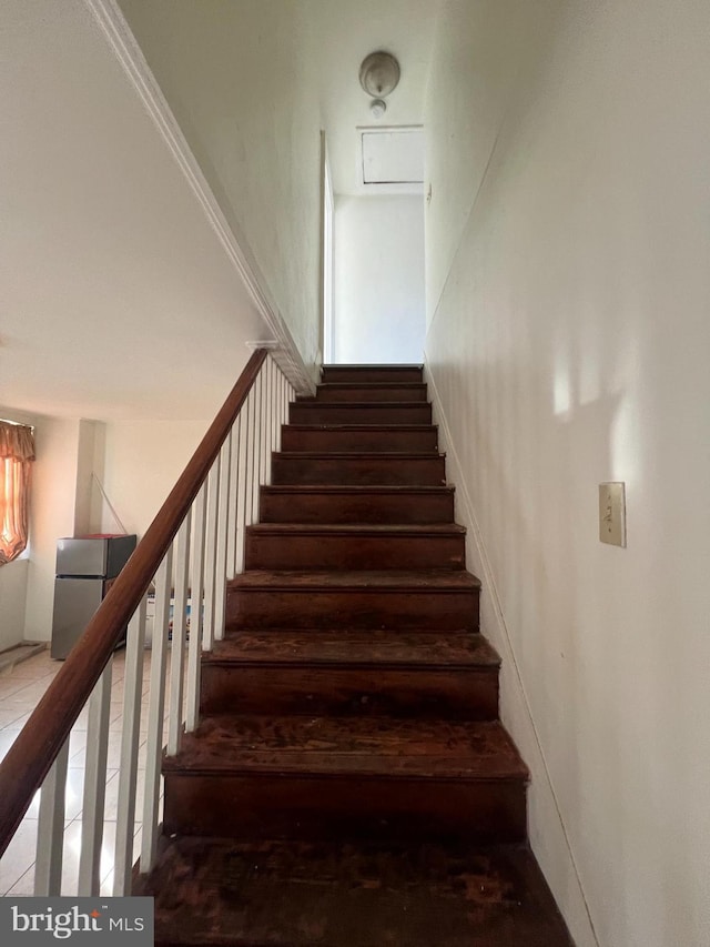 stairway featuring crown molding