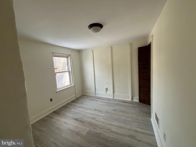 spare room with light hardwood / wood-style flooring