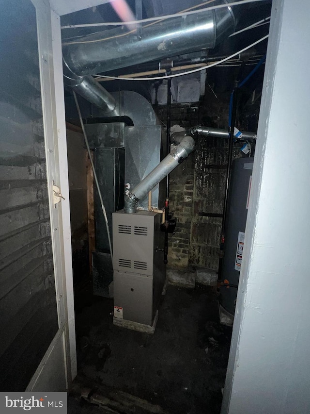 utility room featuring heating unit and water heater