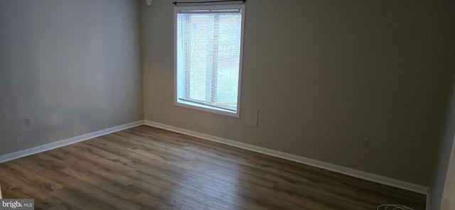 spare room with wood-type flooring