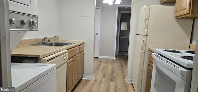 kitchen with stacked washer / drying machine, sink, white appliances, and light hardwood / wood-style floors