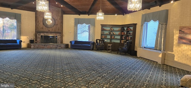 unfurnished living room with beam ceiling, brick wall, wood ceiling, and a fireplace