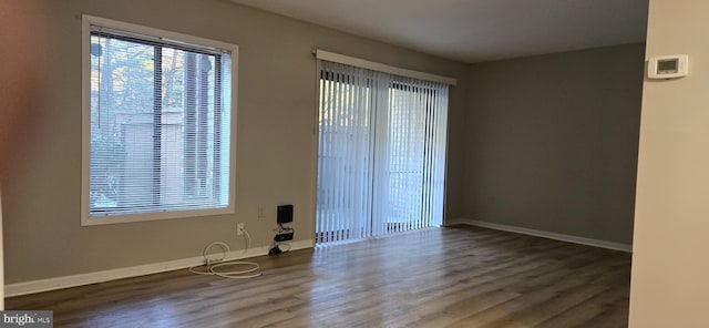 spare room with dark hardwood / wood-style floors