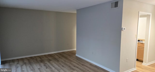 unfurnished room featuring hardwood / wood-style floors