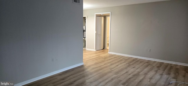 spare room featuring light hardwood / wood-style flooring