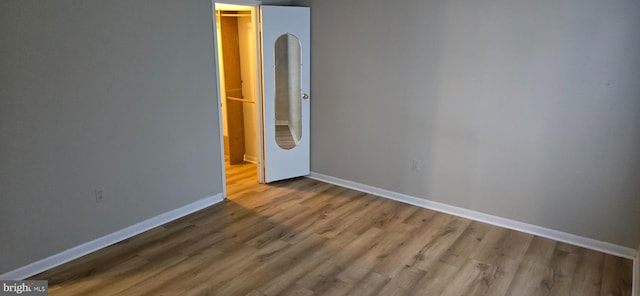 spare room with wood-type flooring