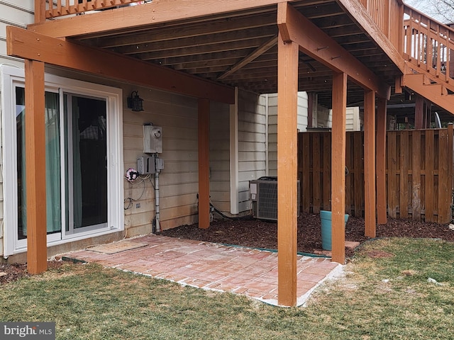 view of patio with cooling unit and fence