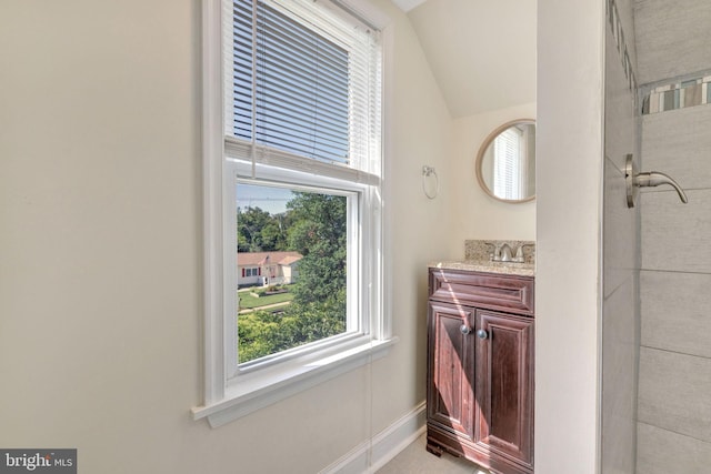 bathroom with vanity and vaulted ceiling