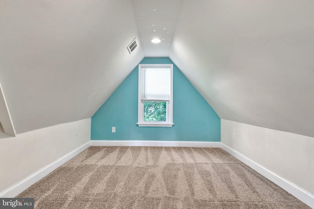 bonus room featuring vaulted ceiling and carpet