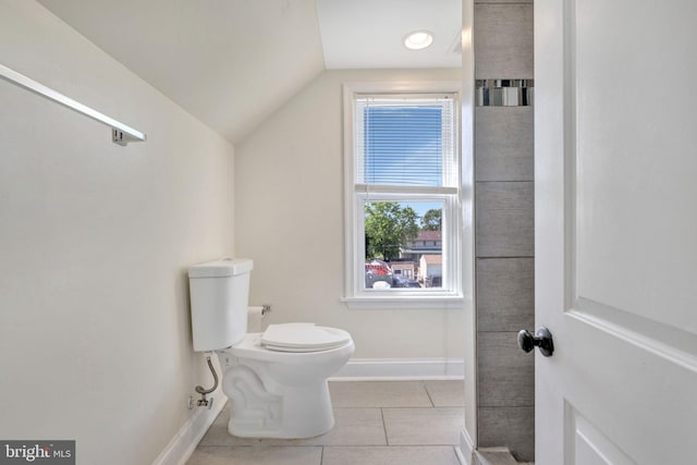 bathroom featuring tile patterned flooring, toilet, and vaulted ceiling