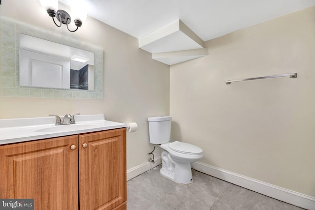 bathroom featuring toilet, tile patterned floors, and vanity