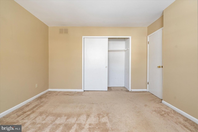 unfurnished bedroom with a closet and carpet