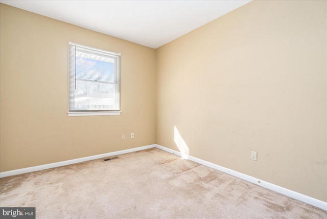 empty room featuring light colored carpet