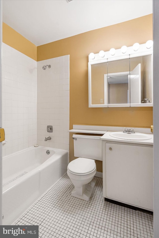 full bathroom featuring tiled shower / bath combo, toilet, tile patterned flooring, and vanity