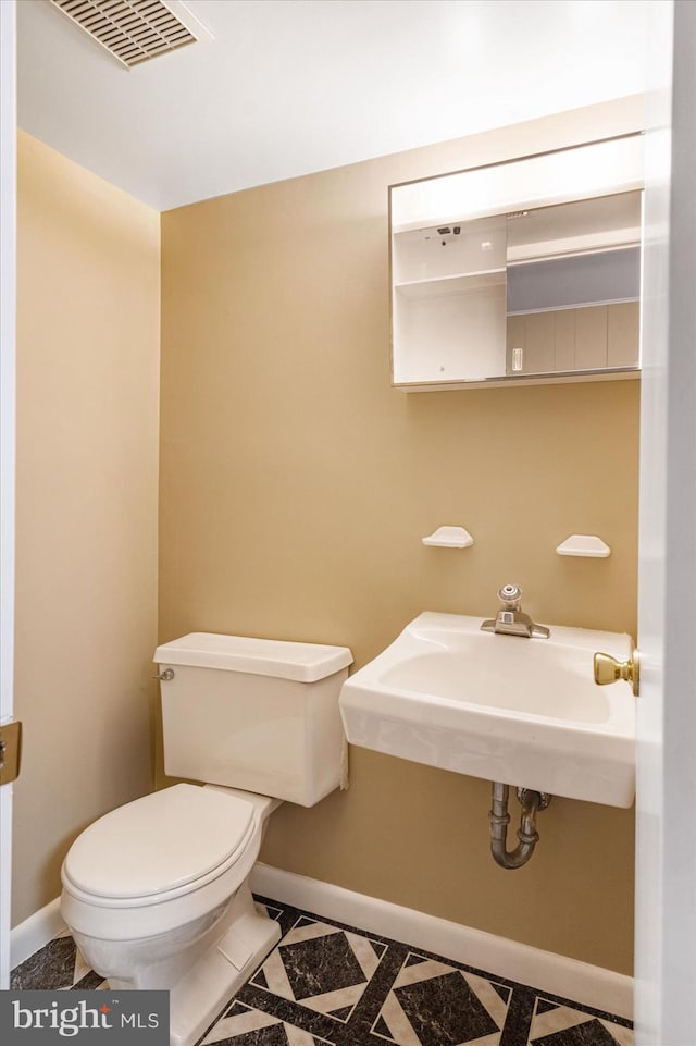 bathroom featuring sink and toilet