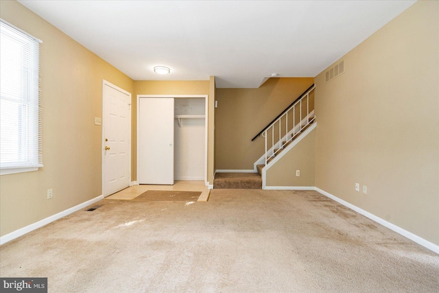 view of carpeted foyer entrance