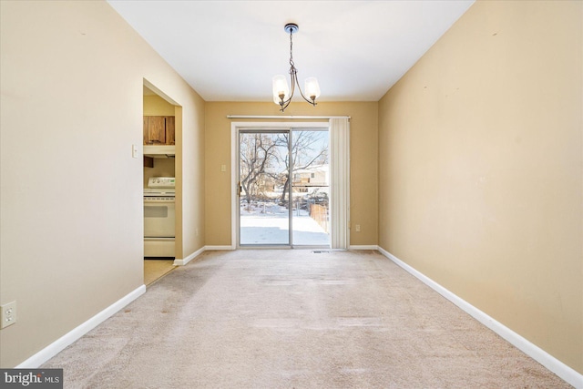 doorway featuring a notable chandelier and light carpet