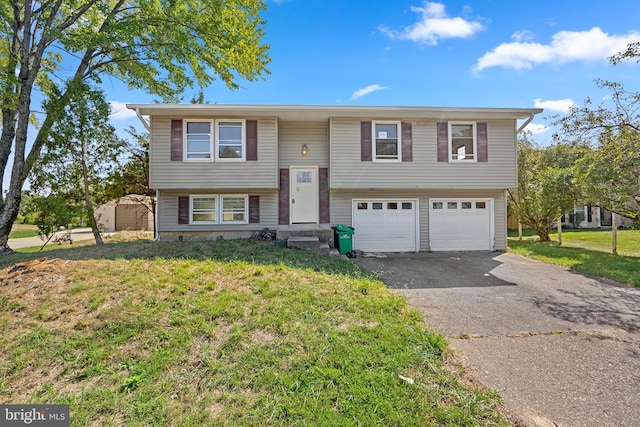 split foyer home with a garage and a front lawn