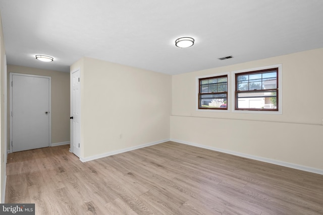 spare room featuring light wood-type flooring