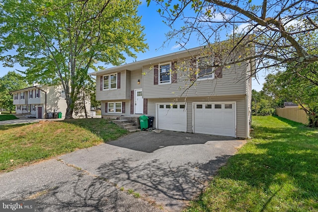 raised ranch with a garage and a front lawn