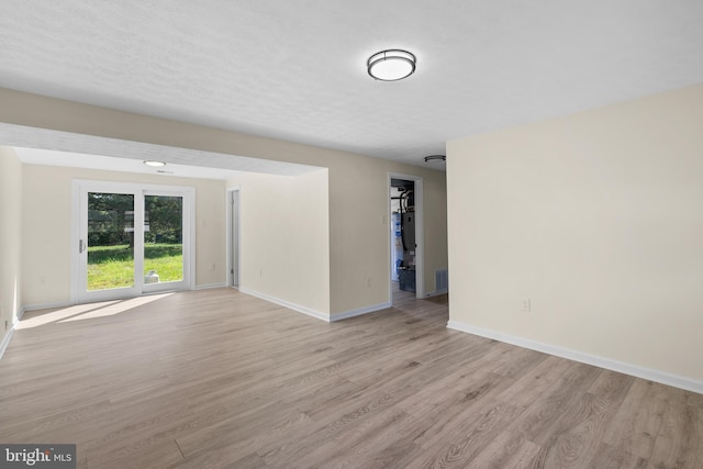 unfurnished room with light wood-type flooring