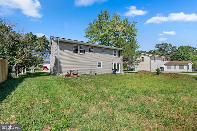 rear view of house with a yard