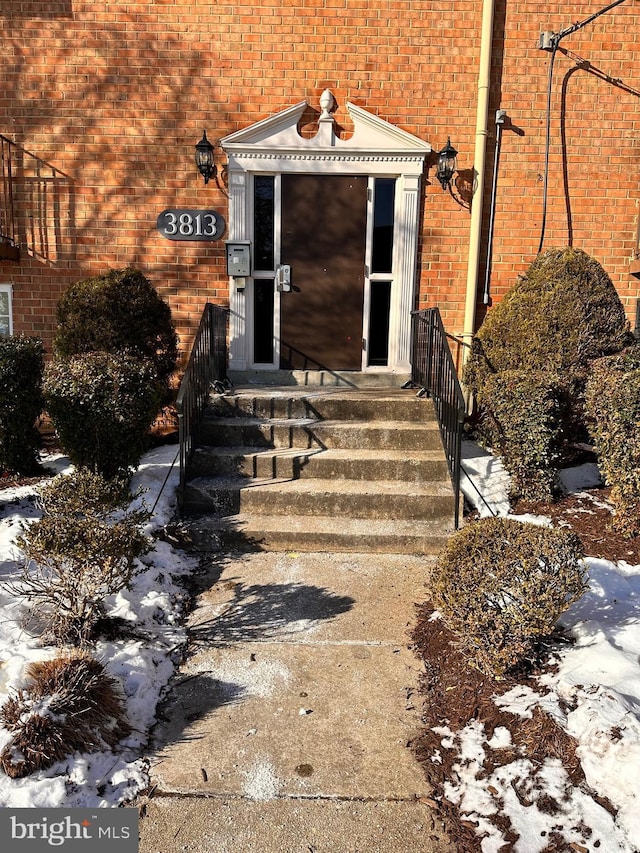 view of snow covered property entrance