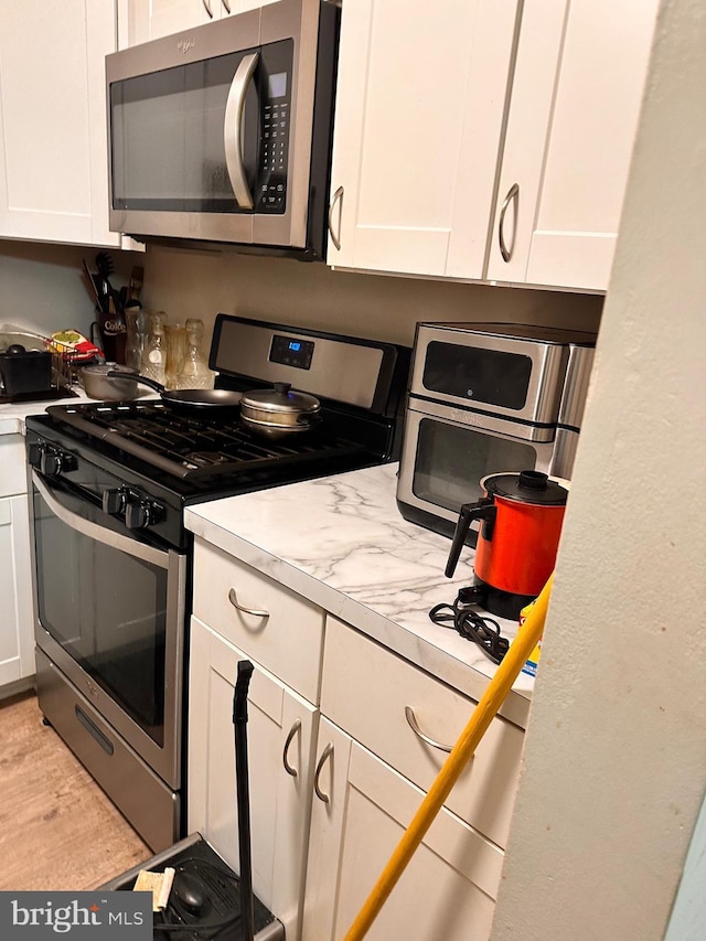 kitchen with white cabinetry and stainless steel appliances