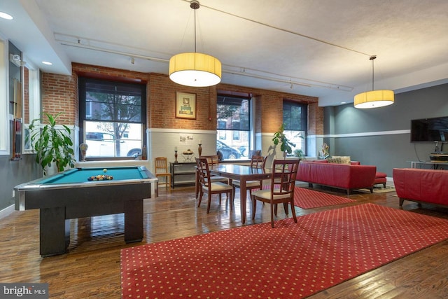 recreation room with a healthy amount of sunlight, track lighting, and wood finished floors