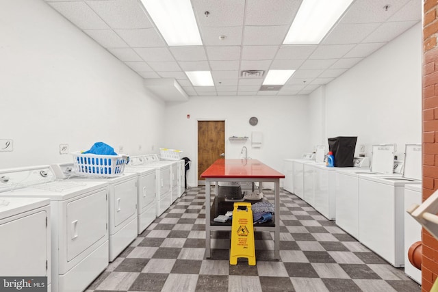 shared laundry area featuring dark floors, separate washer and dryer, and visible vents