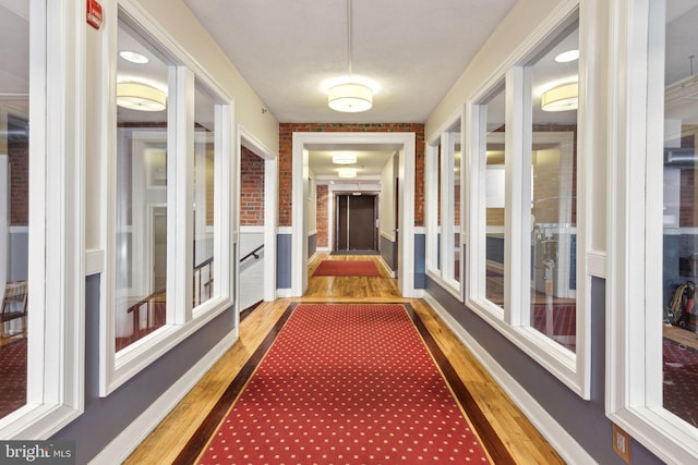 corridor featuring wood finished floors