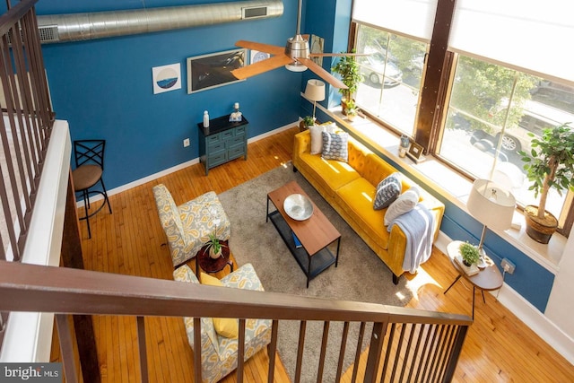 living room with visible vents, baseboards, and wood finished floors