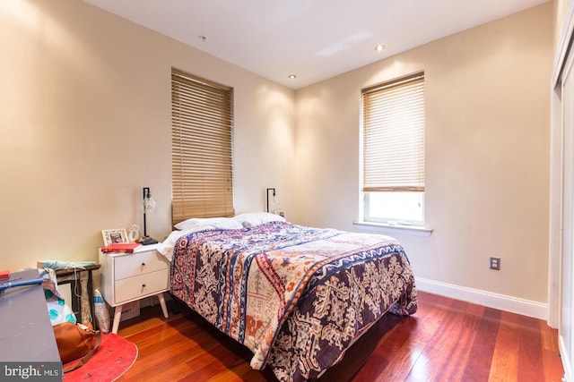 bedroom with dark hardwood / wood-style flooring