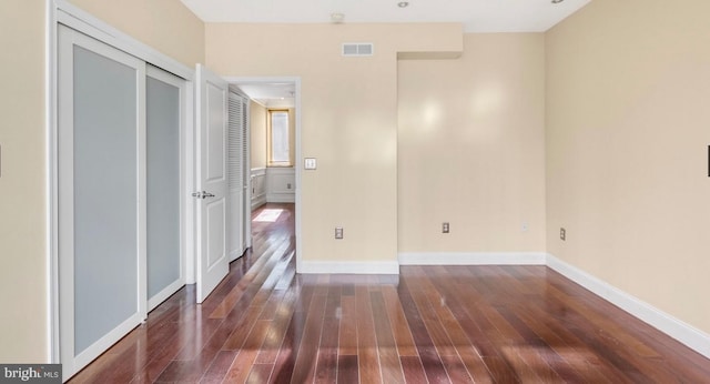 unfurnished bedroom with dark wood-type flooring