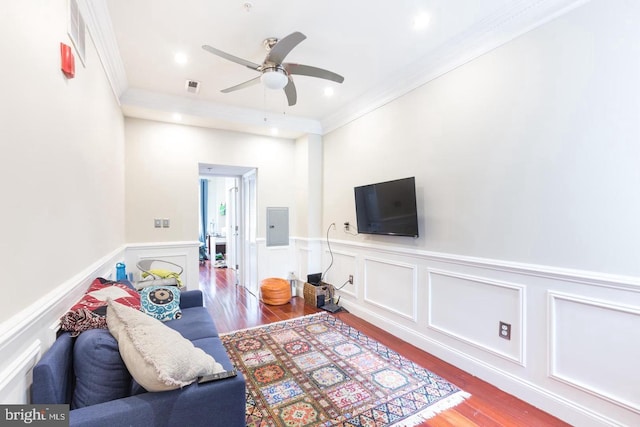 living room with ceiling fan, wood-type flooring, and ornamental molding