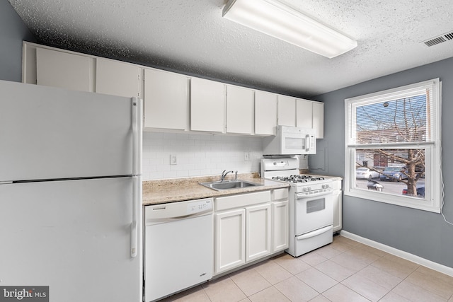 kitchen with tasteful backsplash, sink, white cabinets, white appliances, and a textured ceiling