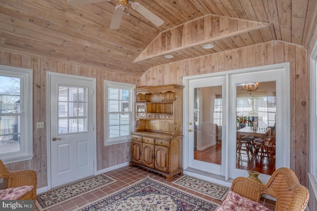 entryway with lofted ceiling, tile patterned floors, wooden ceiling, and wood walls