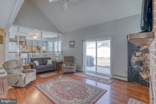 living room with high vaulted ceiling, light hardwood / wood-style floors, ceiling fan, and baseboard heating