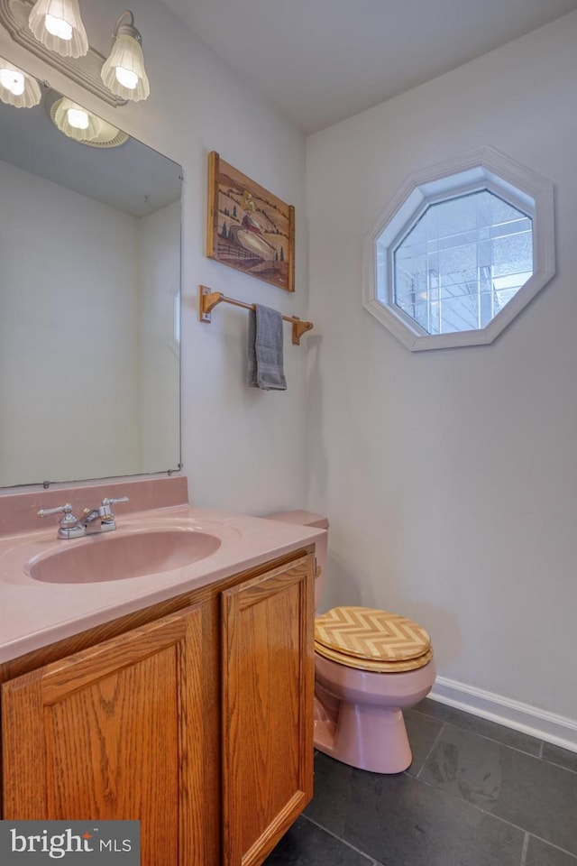 bathroom featuring vanity, tile patterned flooring, and toilet