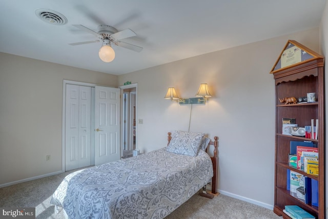 bedroom featuring light carpet, ceiling fan, and a closet