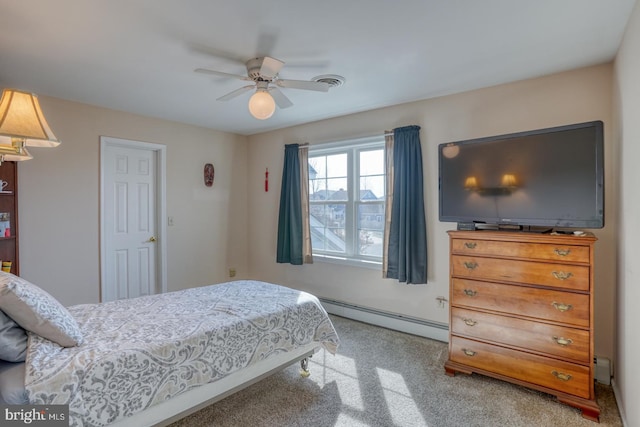 carpeted bedroom with ceiling fan and a baseboard heating unit